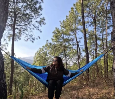 Pabina Basnet relaxing in Langtang Gear hammock outdoors