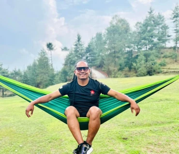Riwaj Tamang relaxing in Langtang Gear hammock outdoors
